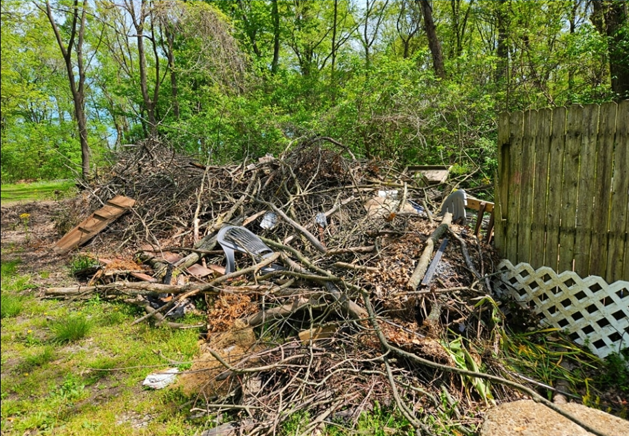 Large brush pile and storm debris removal in Columbus, Ohio, being hauled away by Purefoys Professionals Junk Removal.
